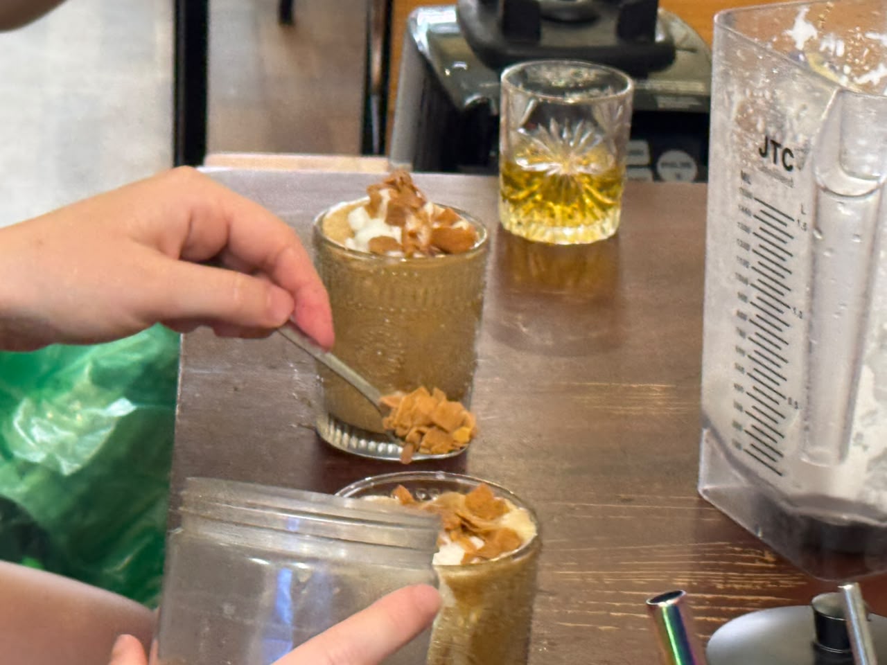 Barista serving finished coffee drinks